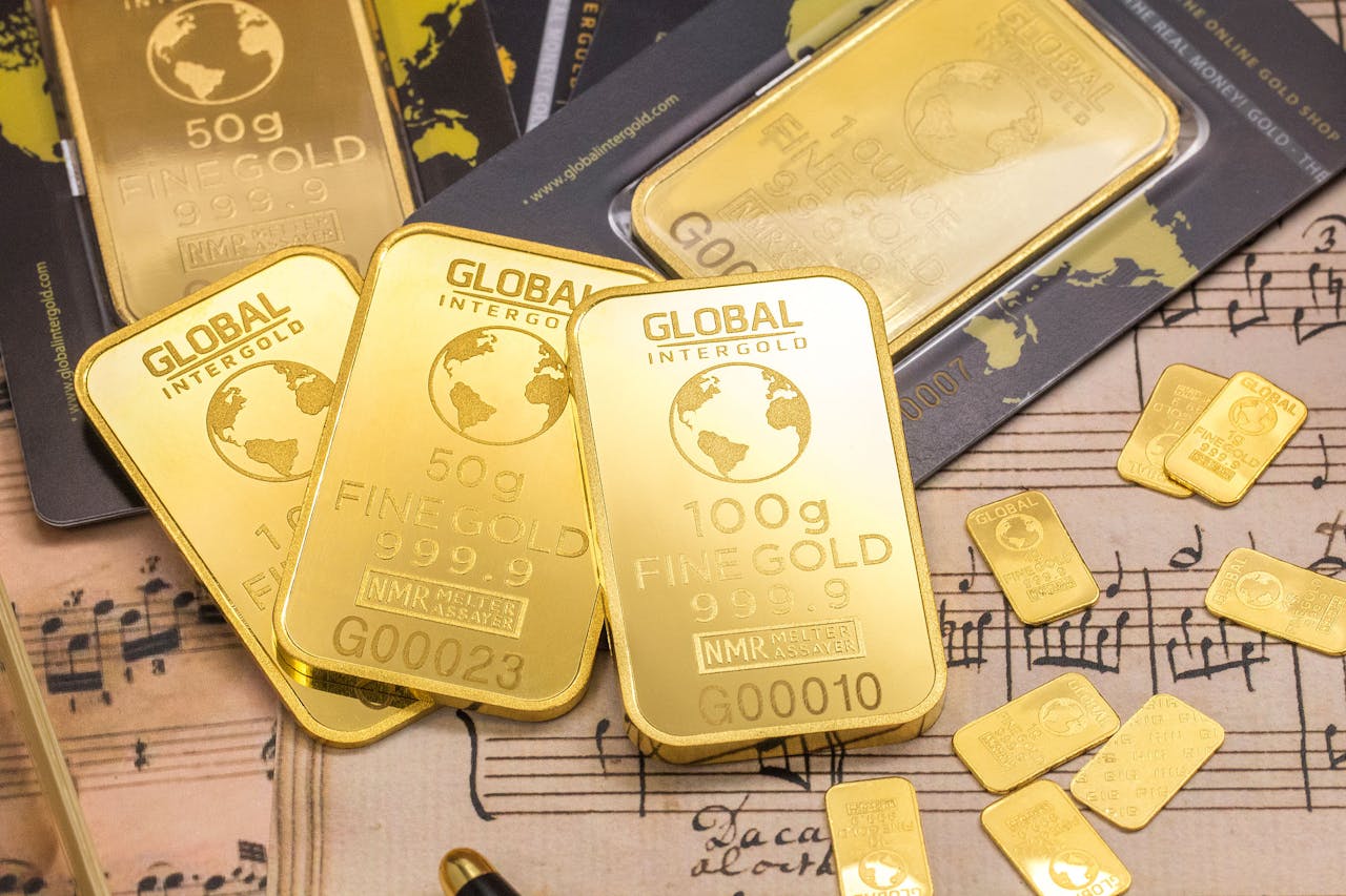 services-04 Gold bars stacked on sheet music, showcasing wealth and luxury with fine detail.